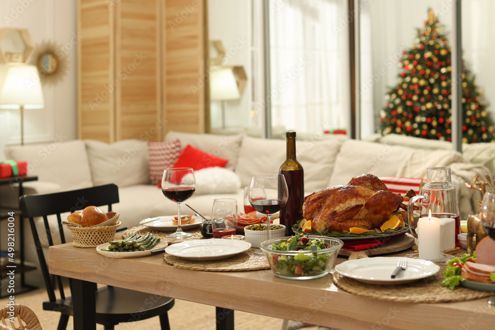 Festive dinner with delicious food and wine on table indoors. Christmas celebration Festive dinner with delicious food and wine on table indoors. Christmas celebration
