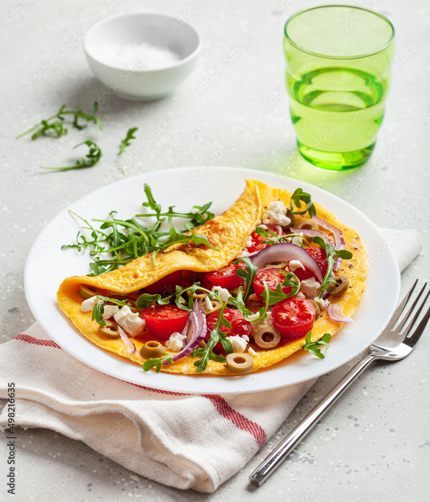 omelette with tomato, feta cheese onion and arugula. healthy keto diet low carb breakfast