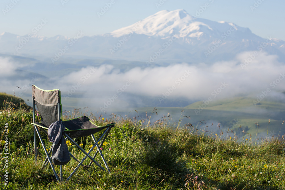 tourist chair stands on edge of mountain, landscape background. travel to elbrus tourist chair stands on edge of mountain, landscape background. travel to elbrus