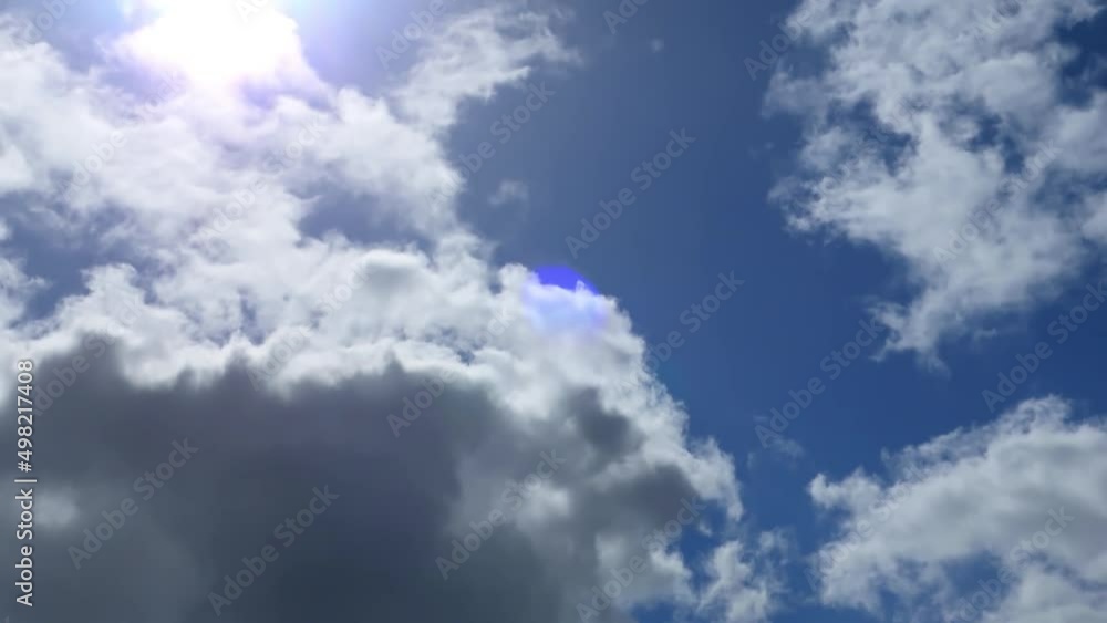 Dense clouds run and end on the blue clear sky Timelapse. Rays of lightning and lance flare break through the movement of white clouds. Cloudscape moving background. Dense clouds run and end on the blue clear sky Timelapse. Rays of lightning and lance flare break through the movement of white clouds. Cloudscape moving background.