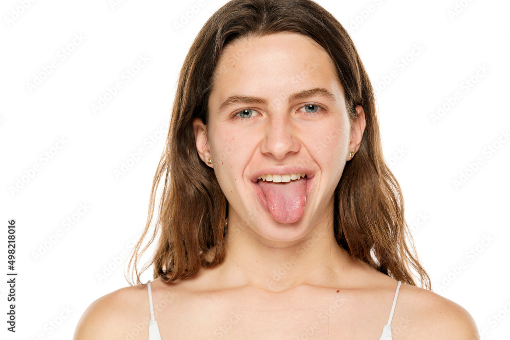 Young woman sticking tongue out on a white background Young woman sticking tongue out on a white background