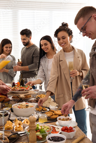 Canvas Print Group of people enjoying brunch buffet together indoors