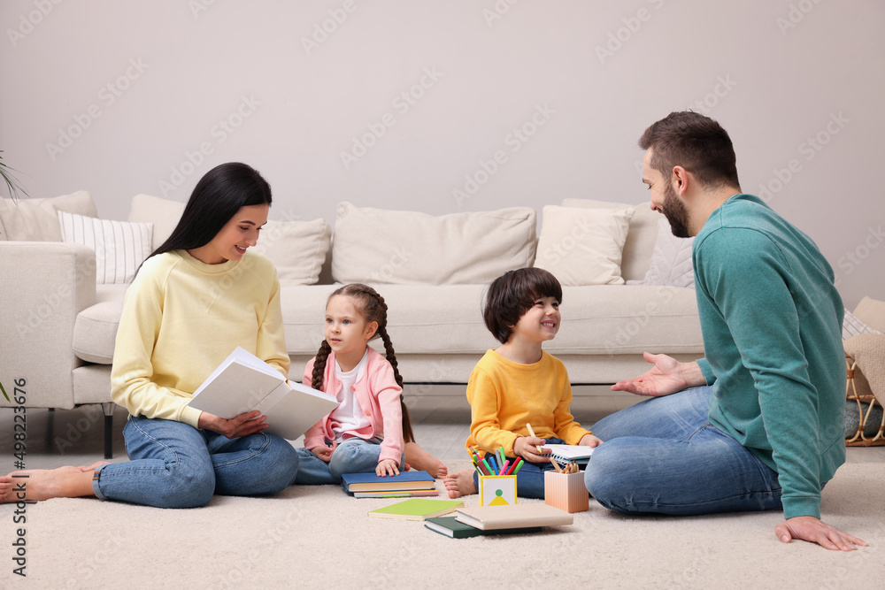Happy family spending time together on floor in living room Happy family spending time together on floor in living room