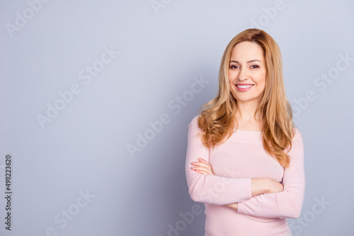 Portrait of satisfied gorgeous girl folded hands toothy smile look camera isolated on grey color background