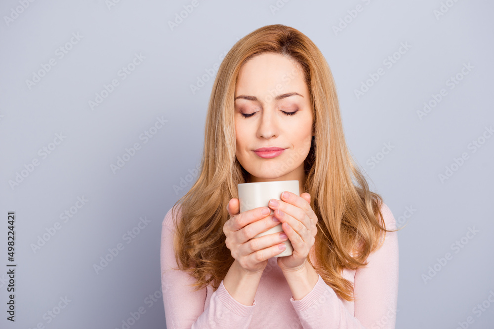 Portrait of peaceful calm girl closed eyes smell fresh cappuccino isolated on grey color background Portrait of peaceful calm girl closed eyes smell fresh cappuccino isolated on grey color background