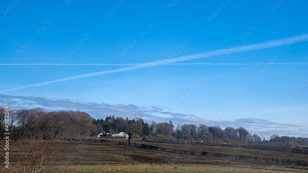 Aircraft Vapour Trail in the Shape of St Andrews Cross Against a Blue Sky a symbol of nationalism in Scotland 