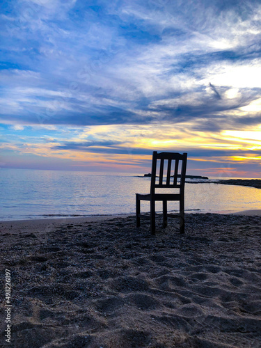 Empty chair on the beach  beautiful sunrise or sunset photo of empty chair the beach. Sad depressed lonely landscape view.