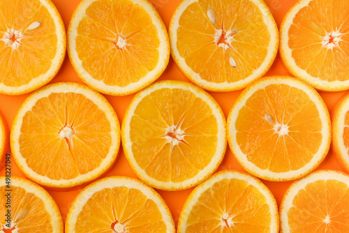 Background of fresh juicy orange slices with pits