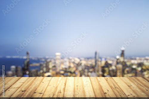 Table top made of wooden dies with beautiful blurry cityscape at twilight on background, mockup