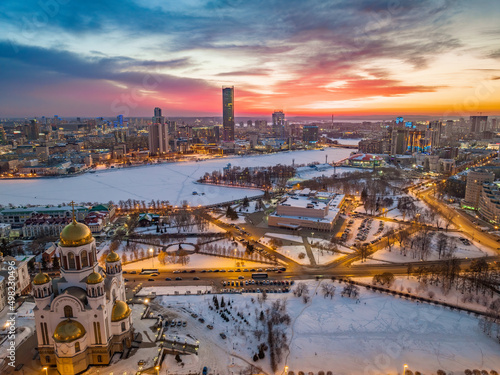 Winter Yekaterinburg and Temple on Blood in beautiful pink and orange sunset. Translation of the text on the temple: Honest to the Lord is the death of His saints. © Dmitrii Potashkin