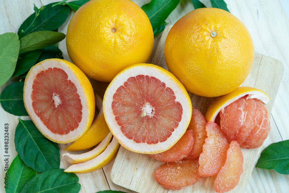 Fresh Grapefruit with leaves on Wooden background, Grapefruit or Yellow Pomelo on Wooden background. Fresh Grapefruit with leaves on Wooden background, Grapefruit or Yellow Pomelo on Wooden background.