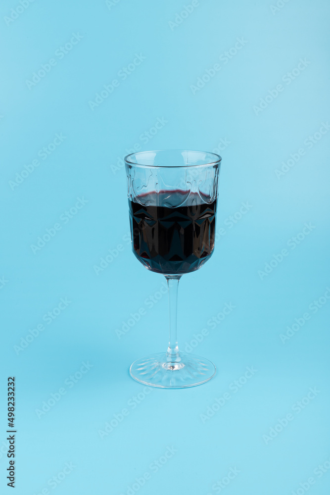Port wine or fortified red wine in a glass on blue background. copyspace. Port wine or fortified red wine in a glass on blue background. copyspace.
