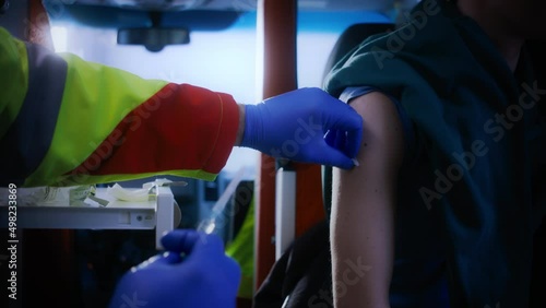 Close Up Shot of an Emergency Medical Care Worker Sanitazing a Caucasian Man Arm Before Giving Him a Vaccination Shot. photo
