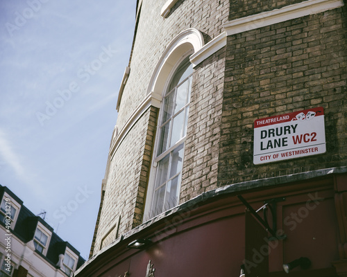 Greater London, London, UK - April 12, 2016: An East London building, against a clear blue sky, shows the Drury Lane street sign. photo