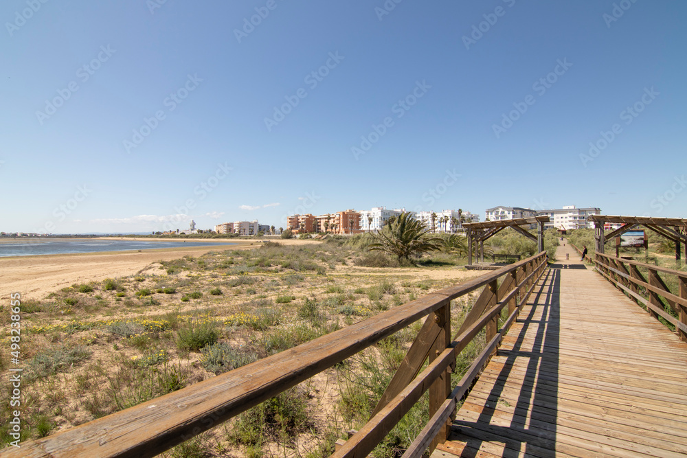 A wooden walkway, on the beach of Isla Cristina, Spain. Widely used by vacationers on vacation. A wooden walkway, on the beach of Isla Cristina, Spain. Widely used by vacationers on vacation.