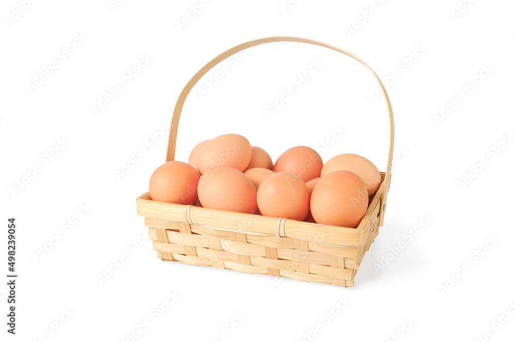 a pile of eggs in a wicker basket isolated with shade a pile of eggs in a wicker basket isolated with shade