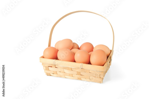 a pile of eggs in a wicker basket isolated with shade