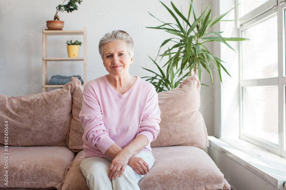 Smiling middle aged mature grey haired woman at home Smiling middle aged mature grey haired woman at home