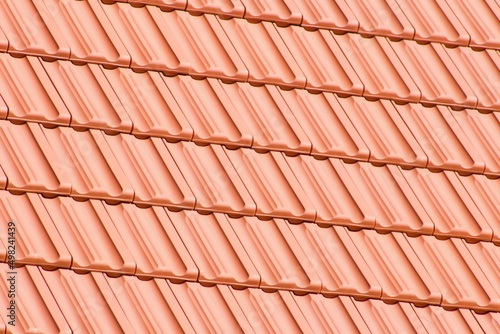 Detail of the new roof of the house with a gabled roof.Orange brick burnt roof tiles. Just laid on a wooden truss.