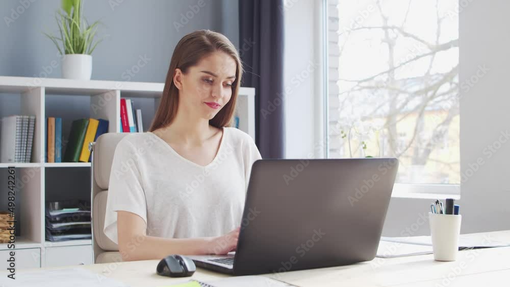 Young Woman Works at Home Office Using Computer. Workplace of Female Entrepreneur, Freelancer or Student. Remote Work and Education Concept. Young Woman Works at Home Office Using Computer. Workplace of Female Entrepreneur, Freelancer or Student. Remote Work and Education Concept.