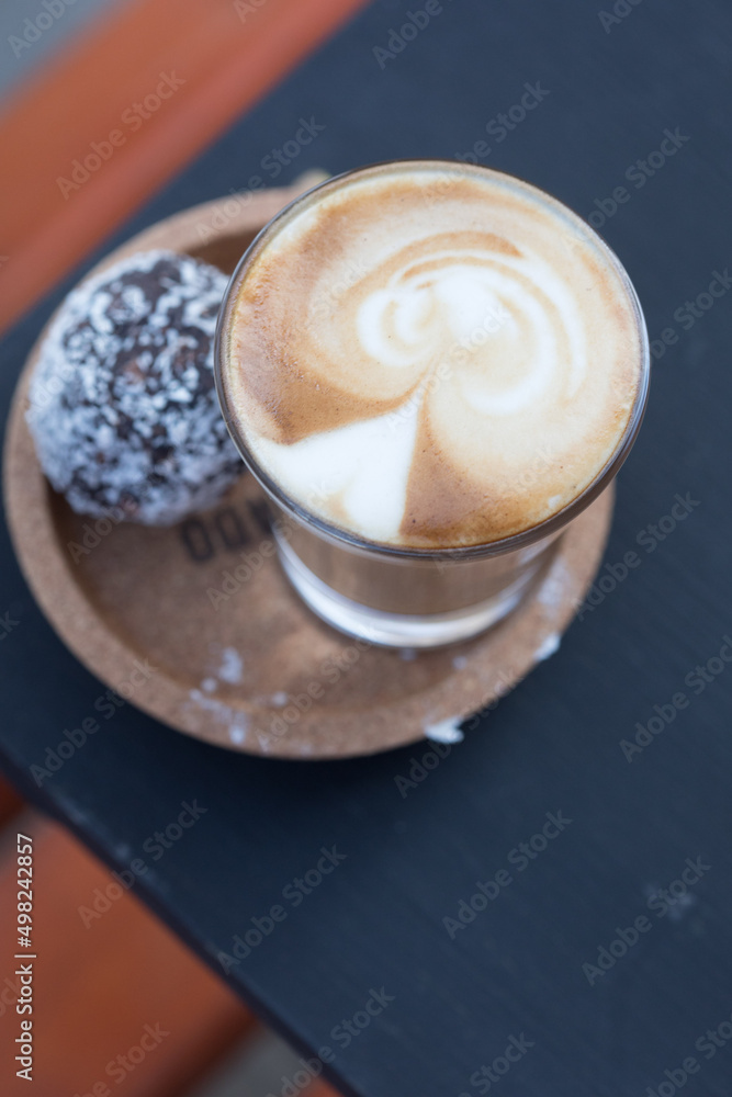 cup of coffee served with a cake ball cup of coffee served with a cake ball