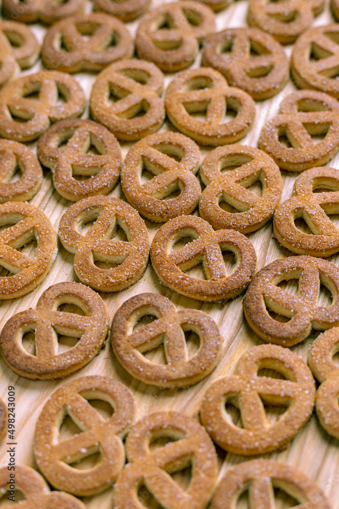 Pretzels sprinkled with sugar lie on a wooden surface Pretzels sprinkled with sugar lie on a wooden surface