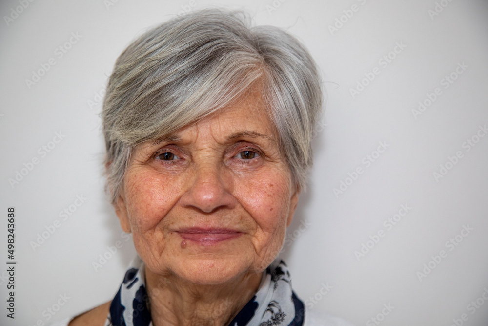 Beautiful 70s middle-aged mature woman looking at camera isolated on white Mature old woman close up portrait. Healthy face skin care beauty, middle age skin care cosmetics, cosmetology concept Beautiful 70s middle-aged mature woman looking at camera isolated on white Mature old woman close up portrait. Healthy face skin care beauty, middle age skin care cosmetics, cosmetology concept