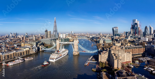 Photography Panoramic aerial view of the skyline of London with the lifted Tower Bridge and