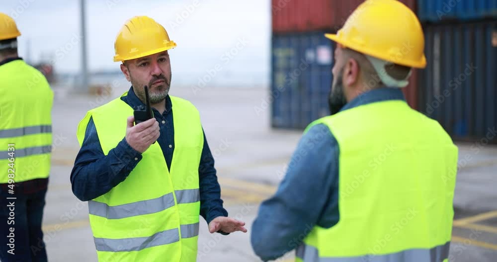 Engineer men controlling shipping containers inside industrial port Engineer men controlling shipping containers inside industrial port