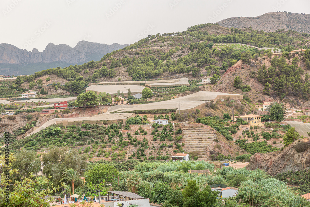 Greenhouses and houses in a valley of the Alicante region in Spain