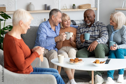 Positive multiracial senior people spending time together at retirement house