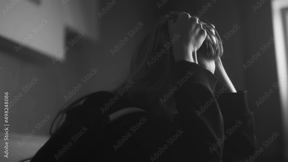 A headache woman is crying and feeling tired, lonely and unhappy at home. Stressed girl is thinking of personal or health problems and suffering from depression or worrying about wrong decision. A headache woman is crying and feeling tired, lonely and unhappy at home. Stressed girl is thinking of personal or health problems and suffering from depression or worrying about wrong decision.