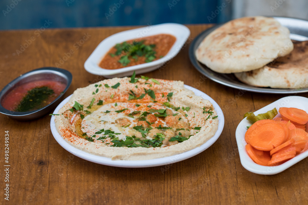 Hummus served with pita bread and sauces Hummus served with pita bread and sauces