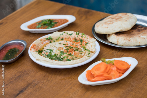 Hummus served with pita bread and sauces 
