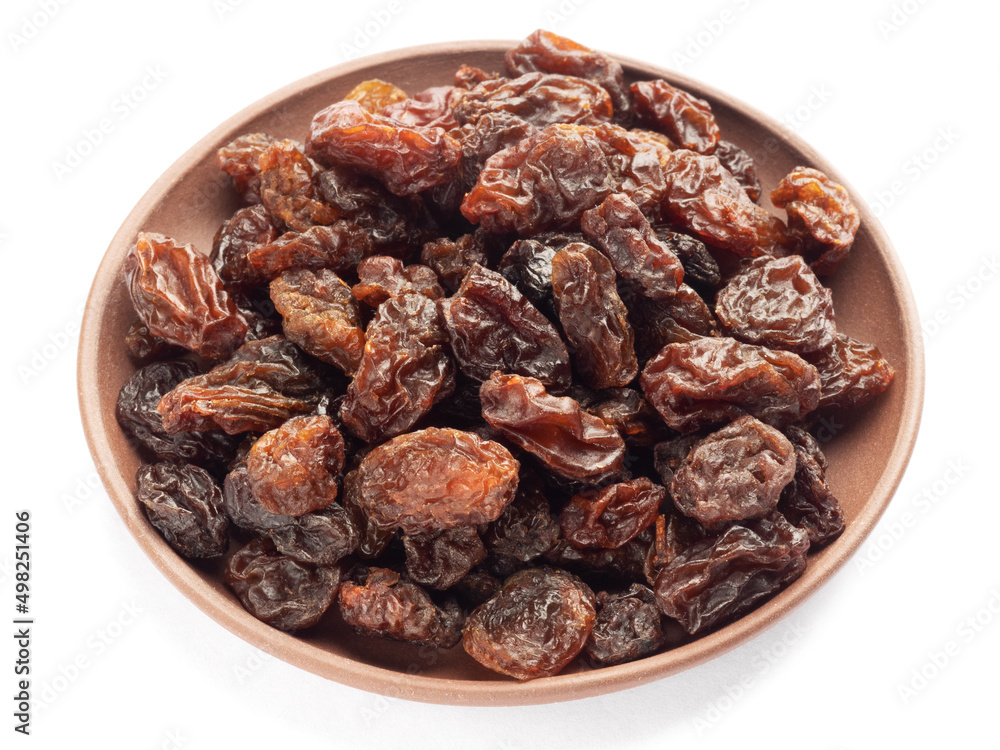 Raisin in clay plate isolated on white background. Macro. Healthy food concept Raisin in clay plate isolated on white background. Macro. Healthy food concept