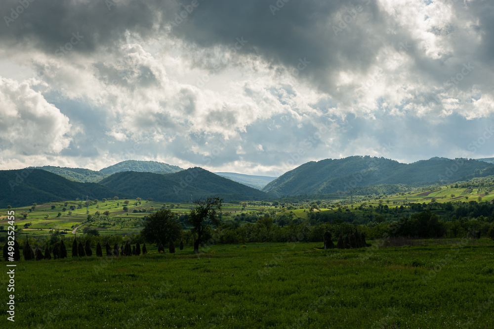 Landscape from Banat region in Romania, next to Timisoara. Summer landscape at the bottom of the hills during a cloudy day.