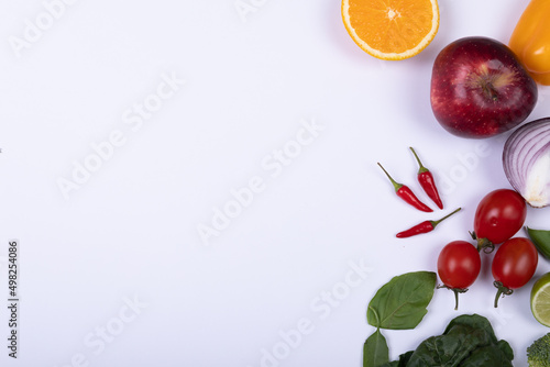 Overhead view of various healthy food on white background with copy space