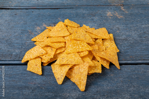 Close-up of crunchy nacho chips on wooden table