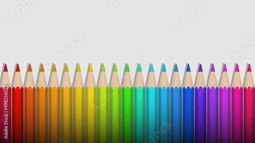 A set of colored pencils arranged in the order of the colors of the rainbow