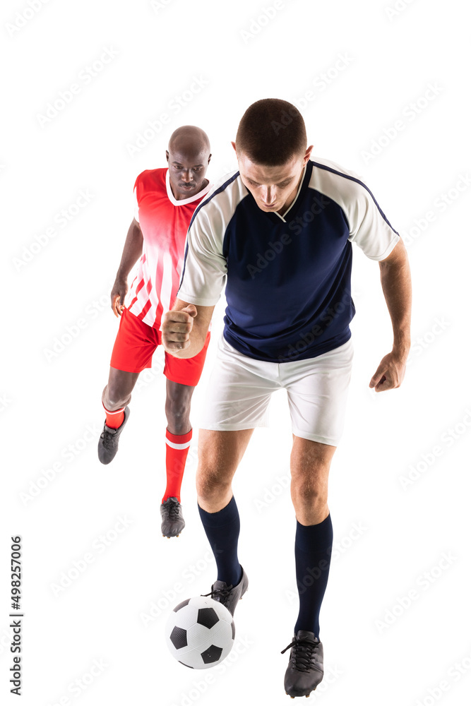 Full length of young male multiracial competitors playing soccer against white background