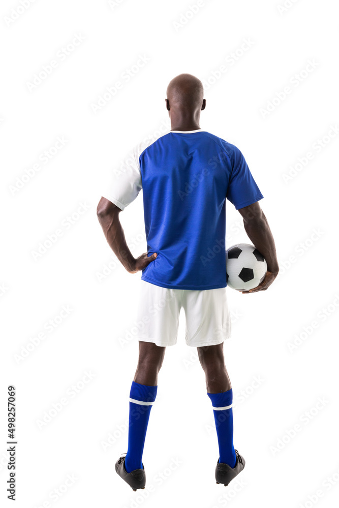Full length rear view of male african american soccer player holding ball over white background