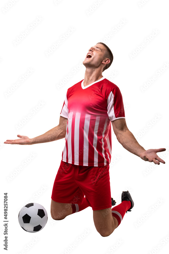 Young male caucasian soccer player celebrating goal by ball against white background