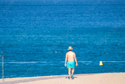 man walking on the beach in the mediterranean © larrui
