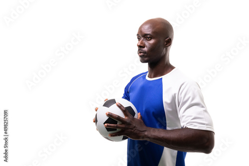Confident african american male soccer player holding ball looking away against white background
