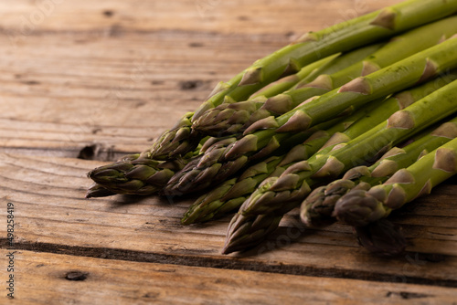 Close-up of raw green asparagus vegetable on wooden table