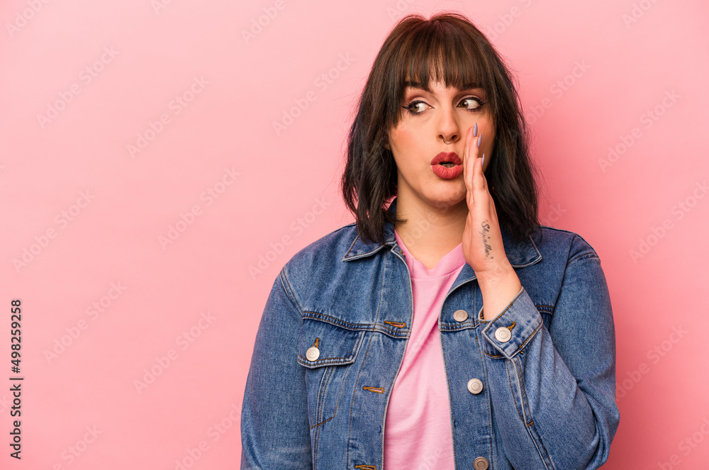 Young caucasian woman isolated on pink background is saying a secret hot braking news and looking aside Young caucasian woman isolated on pink background is saying a secret hot braking news and looking aside