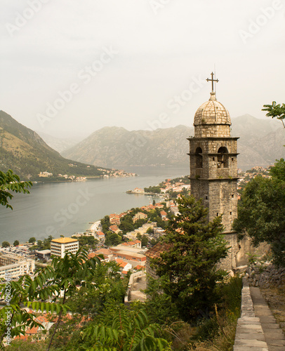 Close-up on the old tower and city on a summer day. Kotor. Montenegro. Location vertical.