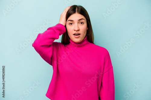Young caucasian woman isolated on blue background being shocked, she has remembered important meeting. © Asier