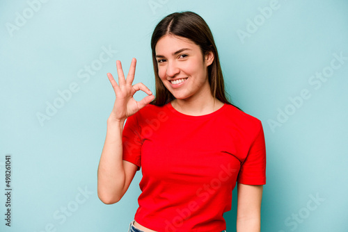 Wallpaper Mural Young caucasian woman isolated on blue background cheerful and confident showing ok gesture. Torontodigital.ca