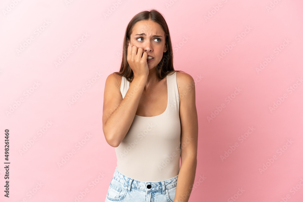 Young woman over isolated pink background is a little bit nervous Young woman over isolated pink background is a little bit nervous